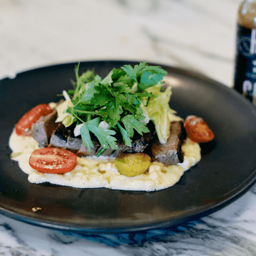 Pan-Seared USDA Prime Sirloin Steak with Creamed Corn and Shaved Fennel Salad Drizzled