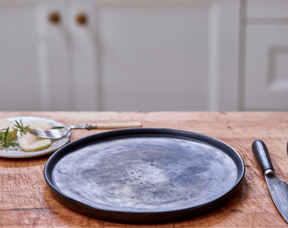 Juicy ribeye being cut on plate