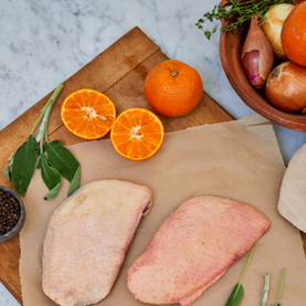 Raw duck breast with oranges