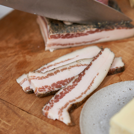 Pancetta being sliced
