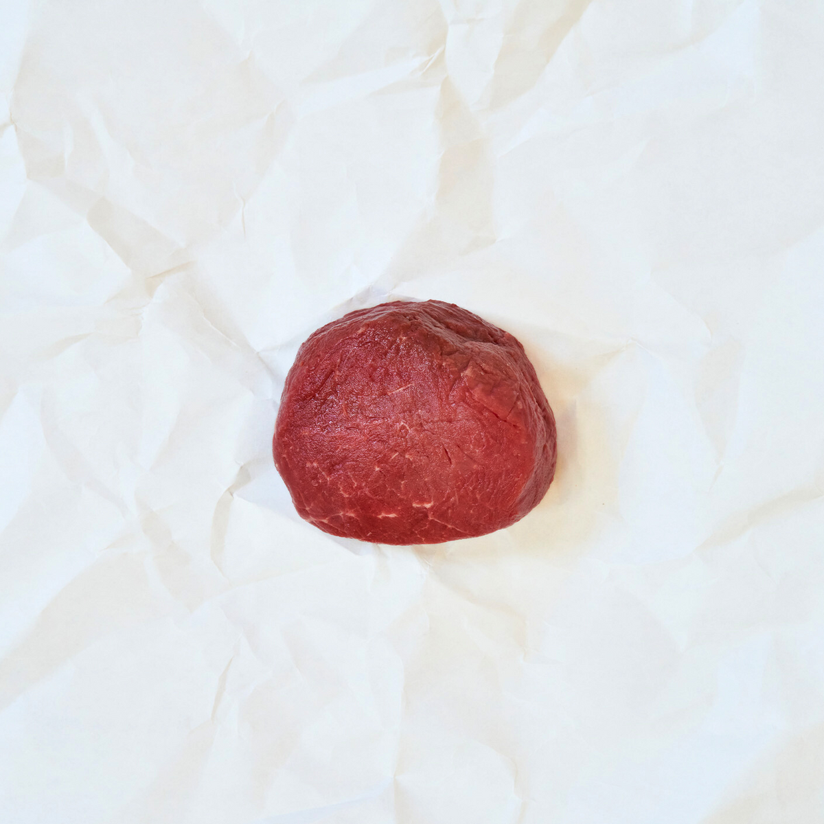 Raw Filet Mignon on white butcher paper
