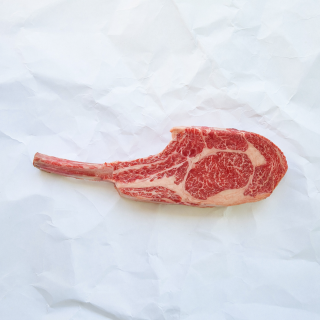 Raw steak on a white marble surface