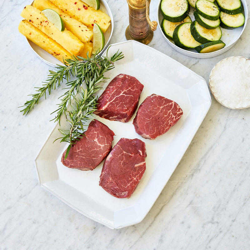 Raw Tenderloin Steak Plated with Pineapple and veggies