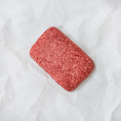 Block of ground lamb on a white background