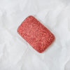Block of ground lamb on a white background