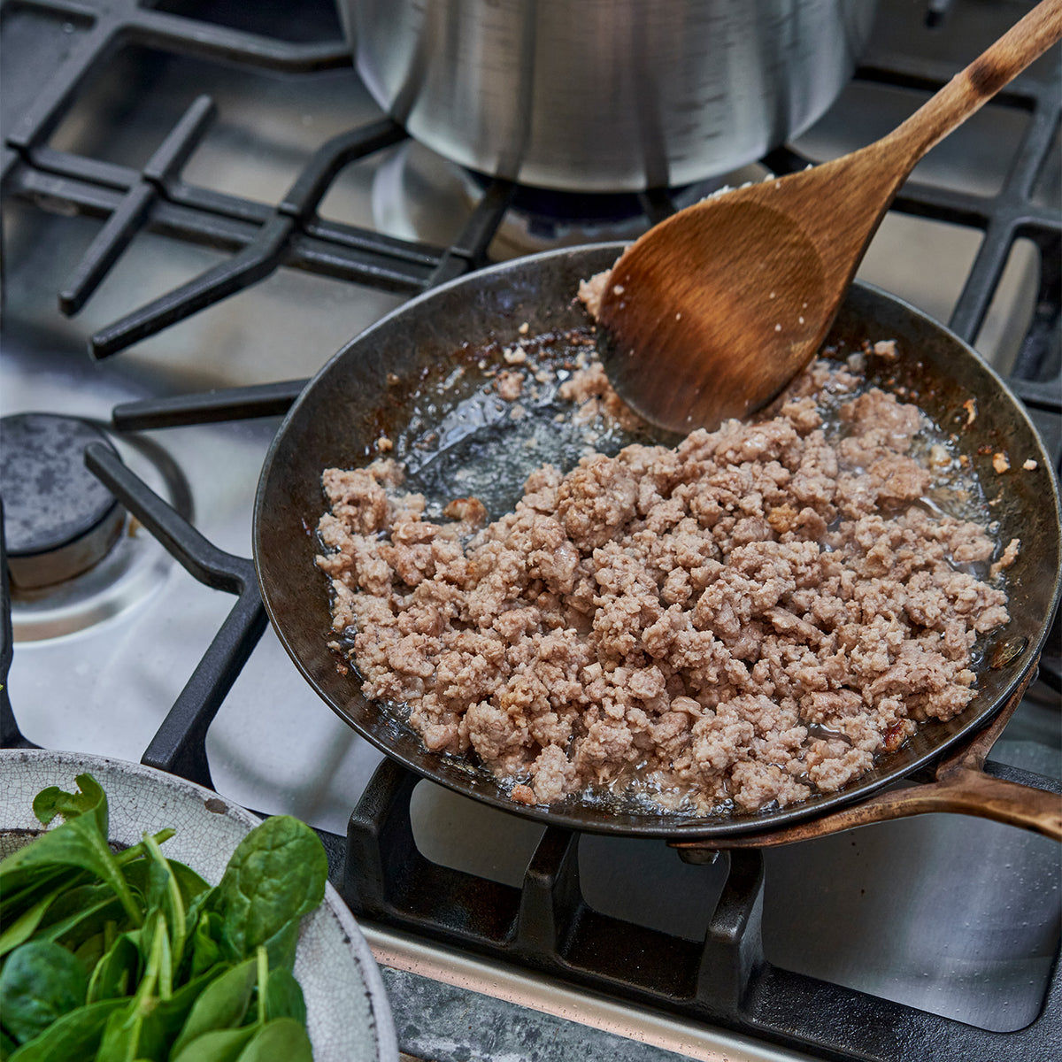 Ground veal being cooked in a skillet 