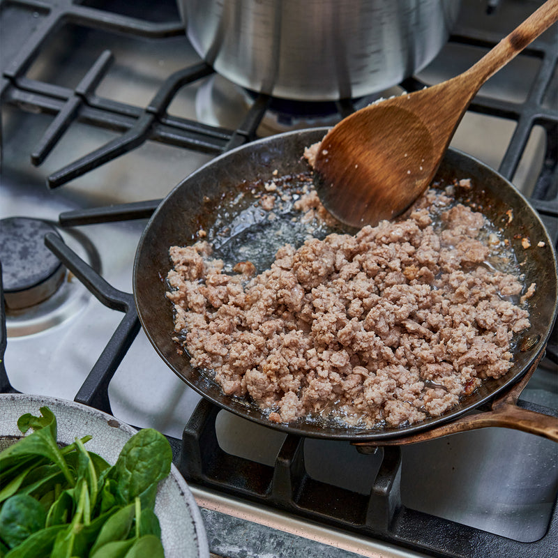 Ground veal being cooked in a skillet 