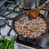 Ground veal being cooked in a skillet 