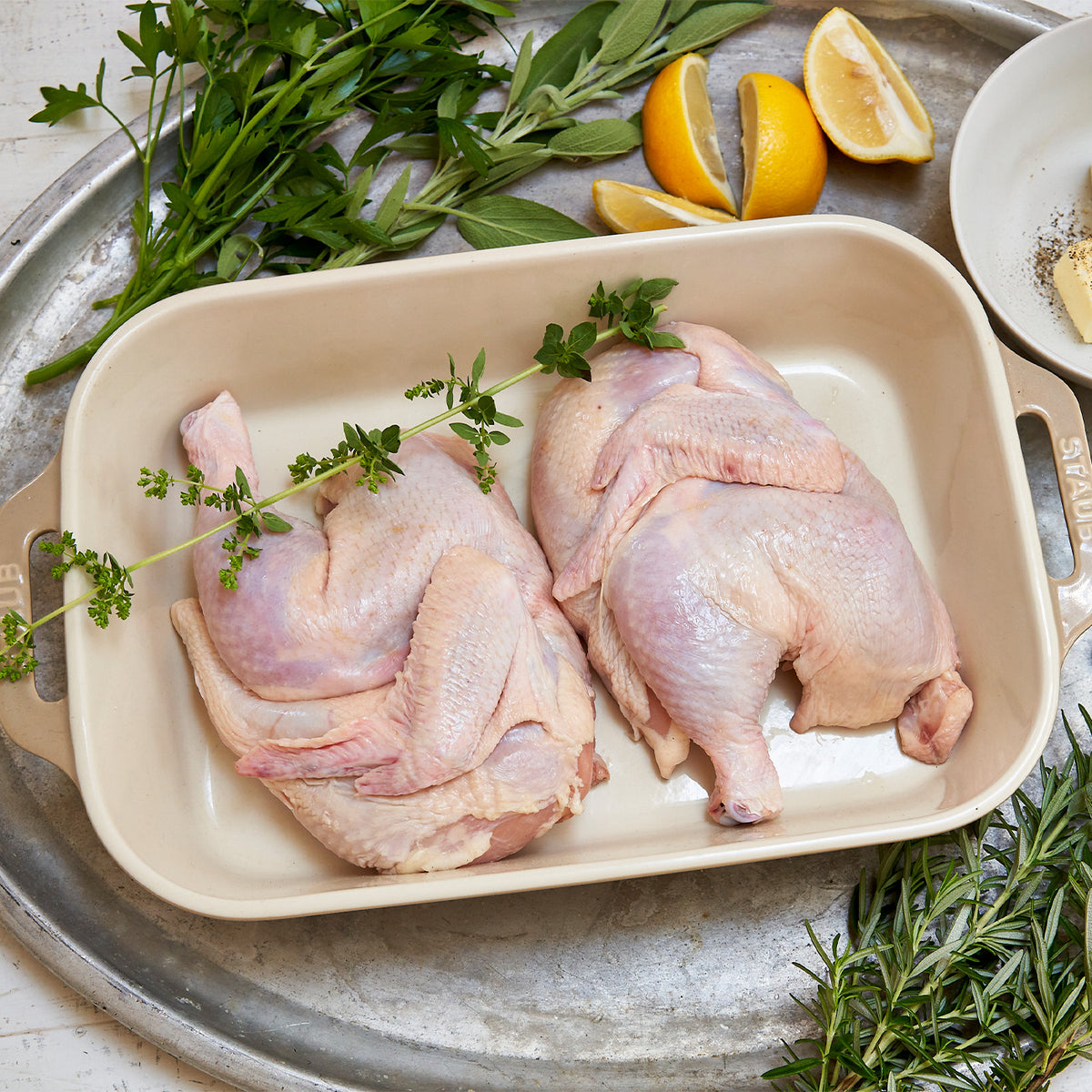 raw half chicken in pan