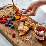 Moulard duck fois grois on sesame seed crackers with a side of fruit 
