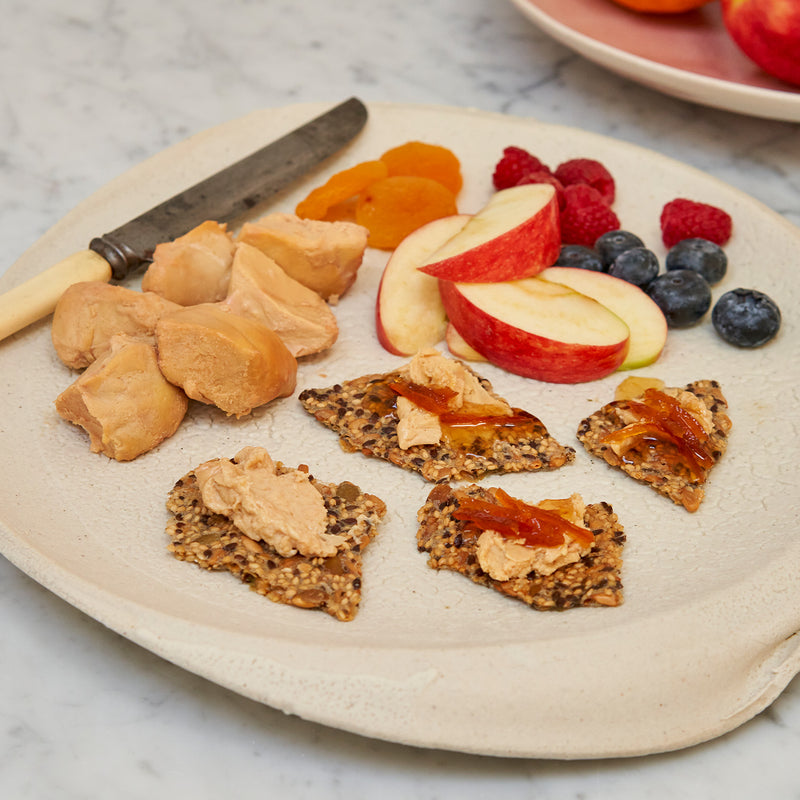 Moulard duck fois grois on sesame seed crackers with a side of fruit 