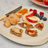 Moulard duck fois grois on sesame seed crackers with a side of fruit 