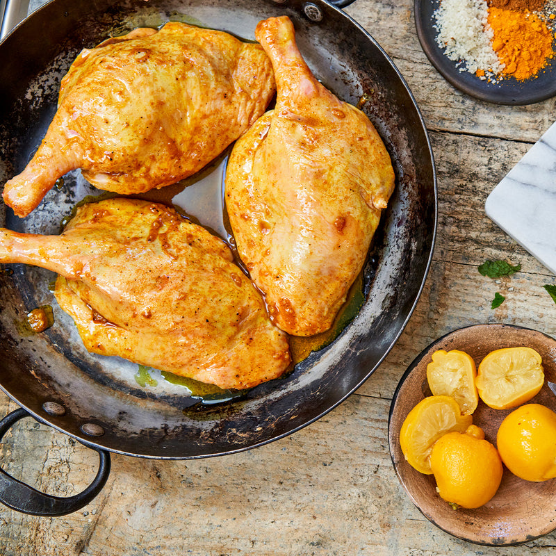 Cooked Moulard deck leg quarters in a skillet 
