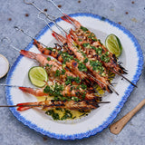 New Caledonia Blue Prawns cooked as skewers on grill and prepared on white platter