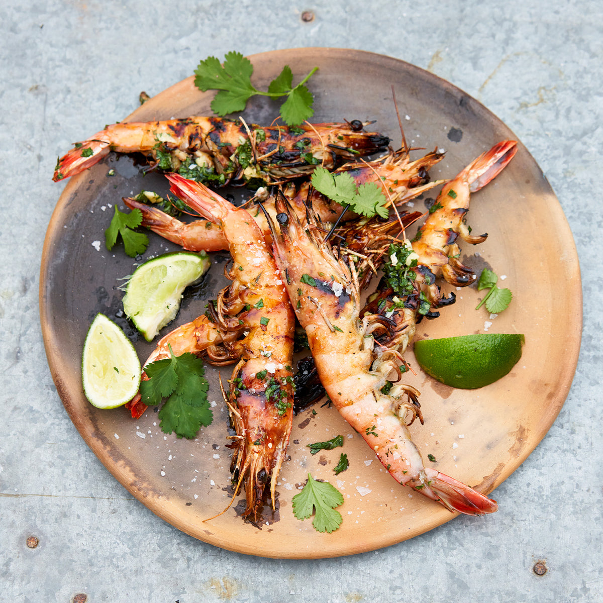 New Caledonia Blue Prawns cooked as skewers on grill and prepared on white platter
