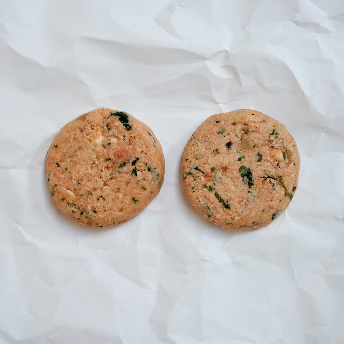 Two round salmon patties on butcher paper