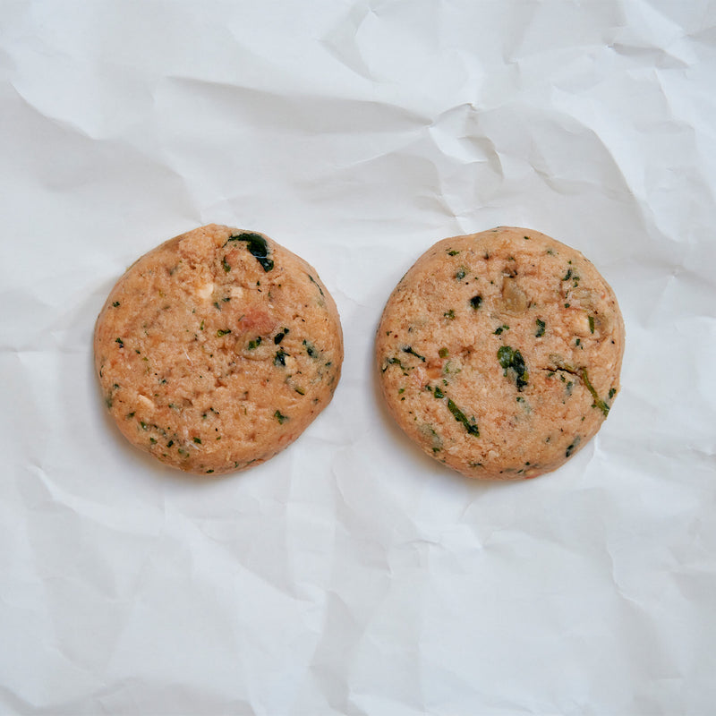 Two round salmon patties on butcher paper