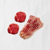 2 raw filet mignons & thick cut bacon on butcher paper