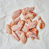 Raw Chicken Wings on white butcher paper