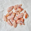 Raw Chicken Wings on white butcher paper