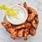 Plated chicken wings with a side of ranch