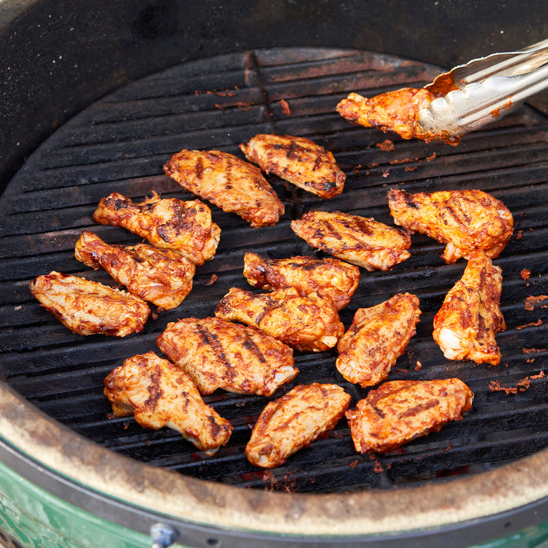 Grilling chicken wings on BBQ