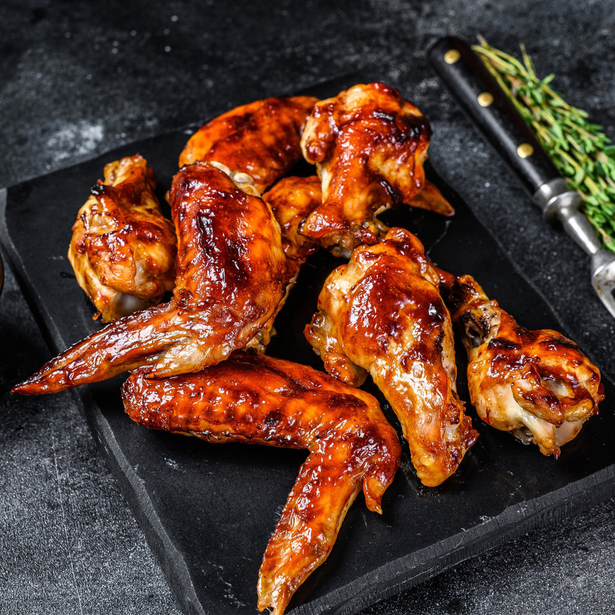 Plated chicken wings with BBQ sauce on top of the wings