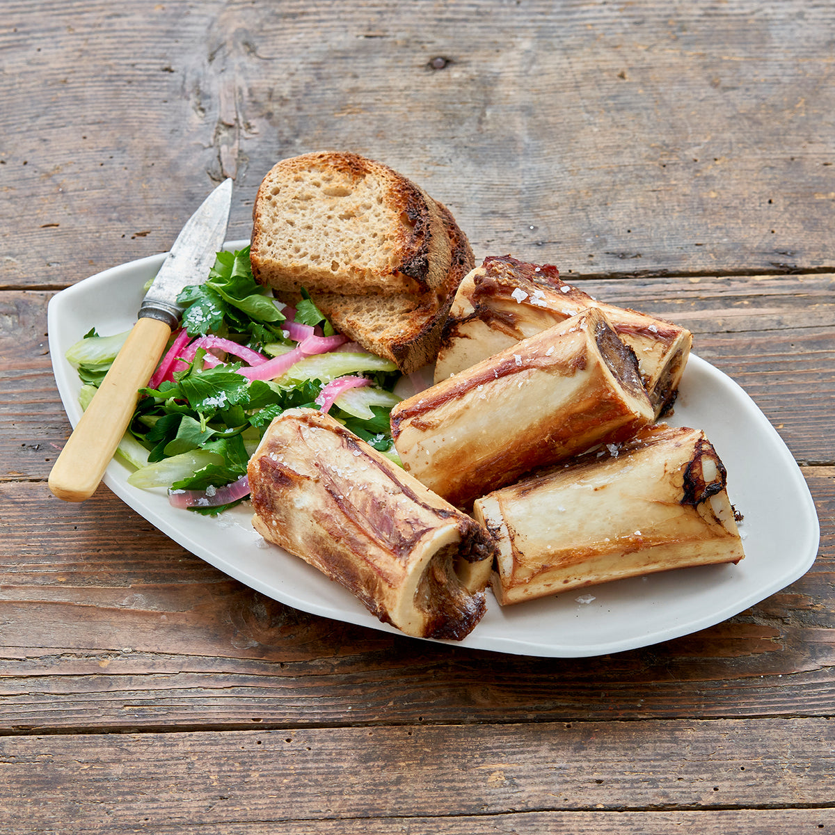 Center Cut Marrow Bones served with bread and salad - Market House