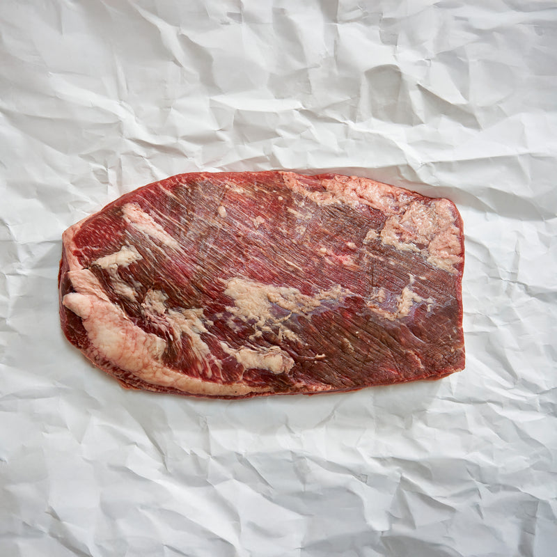 Raw beef brisket on crumpled white paper