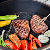 Grilled steak and vegetables on a barbecue grill