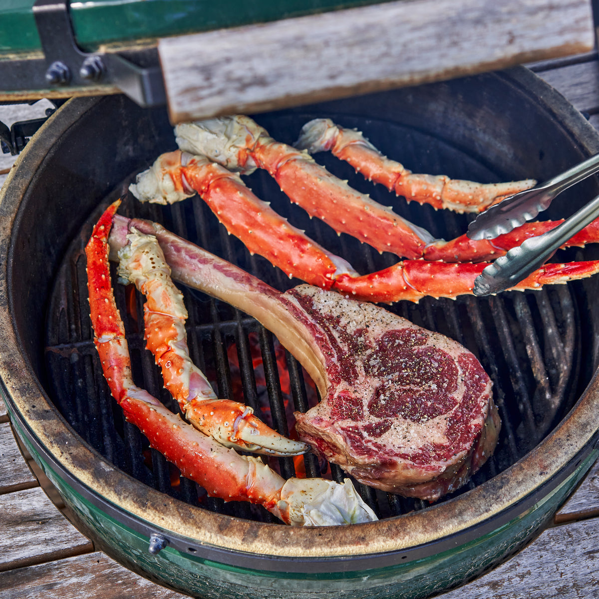 Tomahawk Steak and Red King Crab Legs on grill