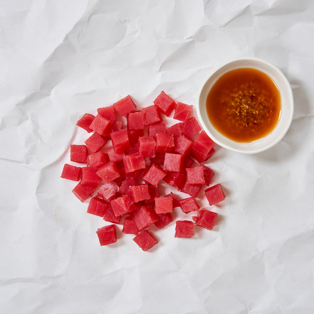tuna poke cubes and wasabi sauce on parchment paper