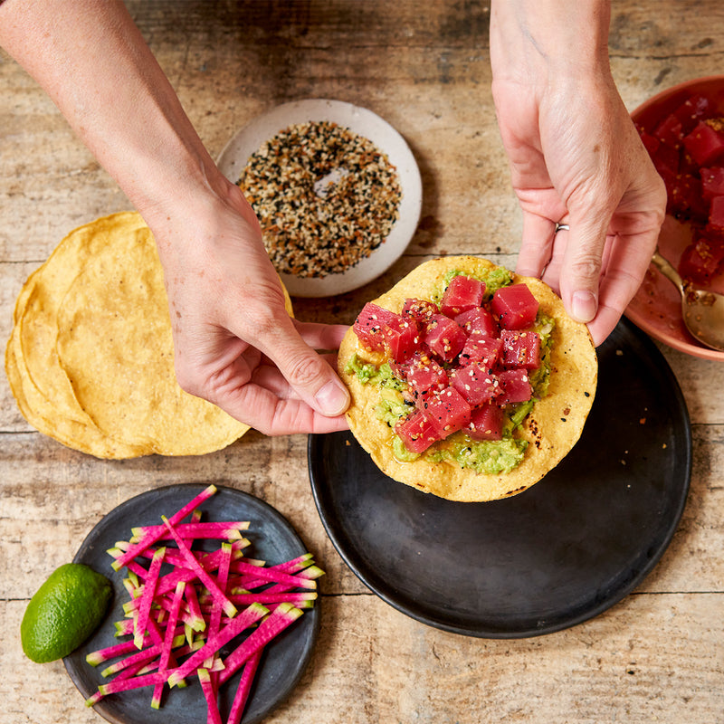 wasabi tuna poke cubea with sesame seeds on tostada