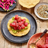 wasabi tuna poke cubes with sesame seeds on tostada