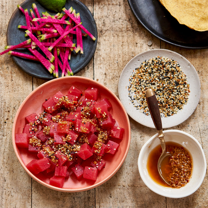 tuna poke cubes in bowl with sesame seeds and wasabi sauce 