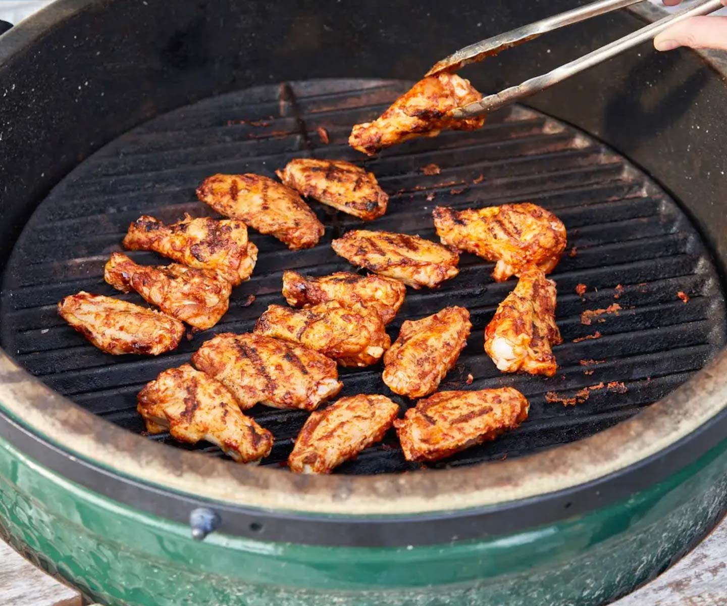 chicken wings being cooked on a grill